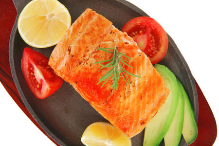 food: roast salmon on metal pan over red wooden plate isolated over white backgroundのeditorial素材
