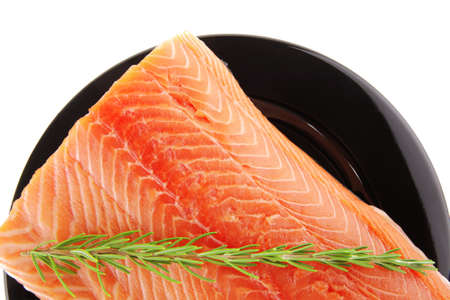 big salmon chunk on black plate over whiteのeditorial素材