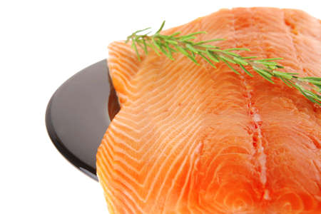 fresh raw salmon fillet on black over white and rosemaryのeditorial素材