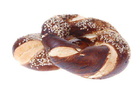 hot mixed pretzels topped by sesame seeds isolated on white background