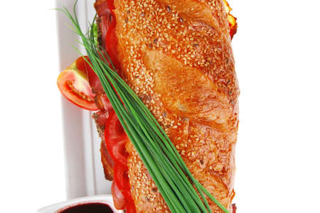 sandwich : french long baguette with smoked chicken sausage on plate with sauces isolated on whiteの写真素材