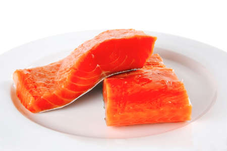 sinlge pink salmon bit on a big white dish