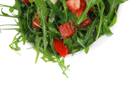 healthy food : salad with raw tomato , garlic , and green staff in white bowl isolated over white backgroundの写真素材