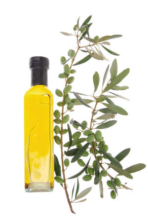 green raw olives with gold oil on white backgroundの写真素材