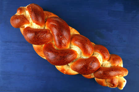 baked product : challah over blue painted wooden board