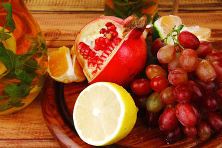 sweet fruits with tea pot on woodの写真素材