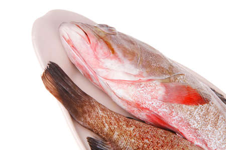 raw fresh sunfish prepared for cooking on ceramic plate