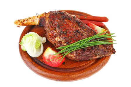 meat on wooden plate : roast shoulder on wood with tomatoes chives and green lettuce isolated on white backgroundの写真素材