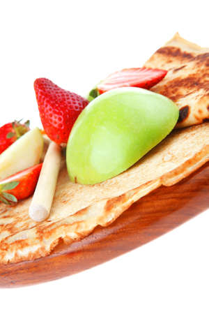 dessert : thin round pancake with honey strawberries and apple isolated over white backgroundの写真素材