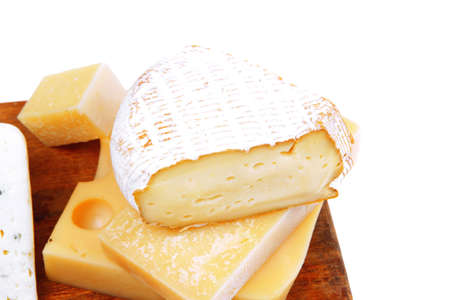 various types of solid french cheese parmesan brie and edam on wooden platter isolated on white backgroundの写真素材