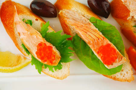 fried salmon on baguettes isolated over whiteの写真素材