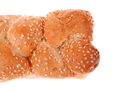 hot bun of light wheat bread topped by sesame seeds isolated over white backgroundの写真素材