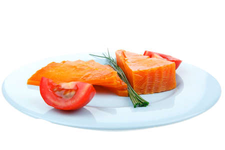 orange aged delicious cheddar cheese chop with slice on blue plate with tomatoes and chives isolated over white backgroundの写真素材