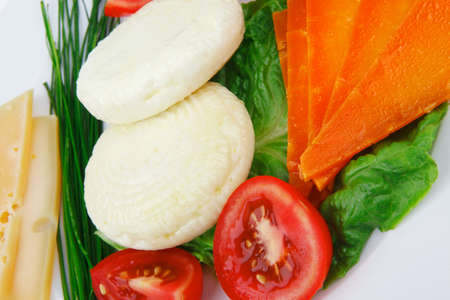 fresh aged cheese : parmesan roquefort and gruyere with soft feta on plate with isolated over white backgroundの写真素材