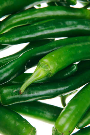 herbs : photo of a bunch of hot green chili peppers isolated over white backgroundの写真素材