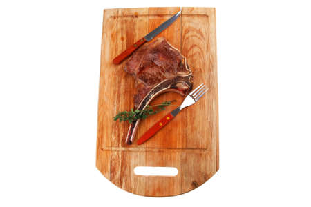 savory : roasted beef spare rib on wooden plate with cutlery and thyme isolated over white backgroundの写真素材