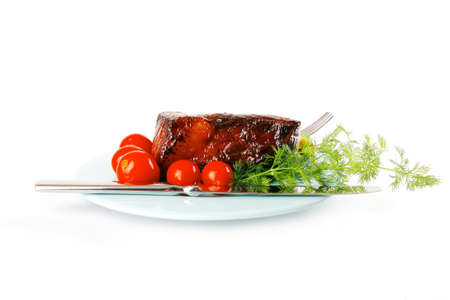 served beef meat chunk and tomatoes on blueの写真素材