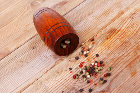 dry pepper with castor on woodの写真素材