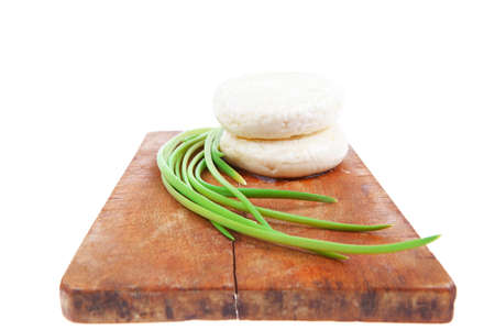 dairy products : feta white cheese on cut board isolated over white backgroundの写真素材