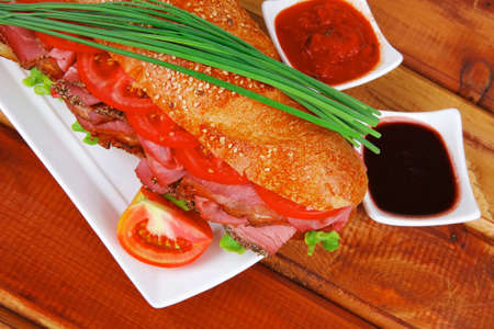 sandwich : fresh white french baguette with chicken smoked sausage on woodの写真素材