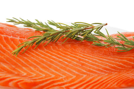 fresh raw red fish fillet on white plate and rosemaryの写真素材