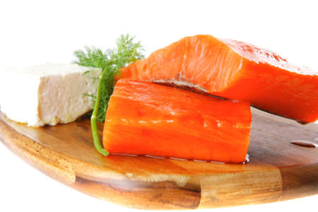 smoked fresh salmon piece with olives and white cheeseの写真素材