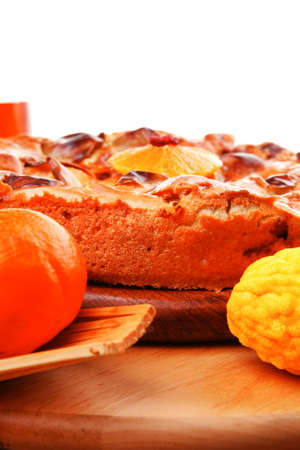 baked food : big apple pie served with fresh apples, raw lemon and mandarin,  tea cup on wooden...