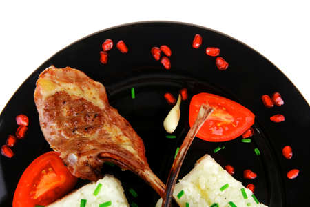 meat savory: roast veal ribs with rice garnish and pomegranate seeds over white background