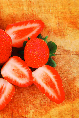 fresh berry: ripe raw strawberry over wooden plateの写真素材