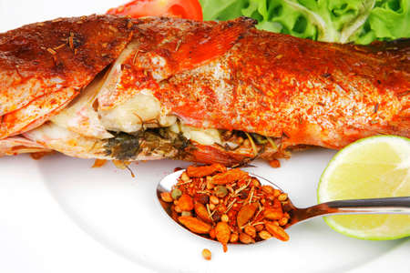 savory on wood: fried fish served with tomatoes lemon and spices
