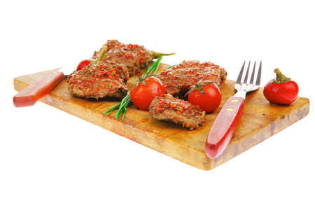 roasted spicy meat over white with cutleryの写真素材