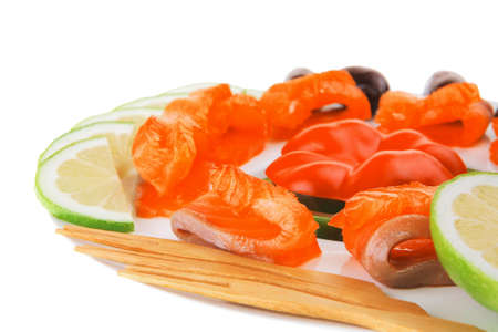 fresh smoked salmon slices on white with olivesの写真素材