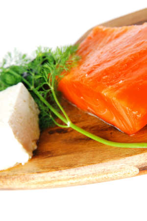 smoked fresh salmon piece with olives and white cheeseの写真素材