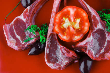 uncooked meat ribs served on red plateの写真素材