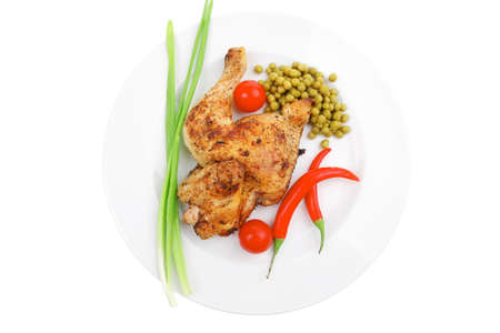 meat savory : chicken legs  grilled and garnished with green onion and red chili hot pepper on white...