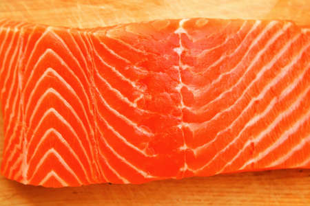 raw salmon fish piece on wooden tray isolated on white background