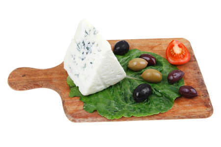 roquefort cheese on wooden platter with olives and tomato isolated over white background