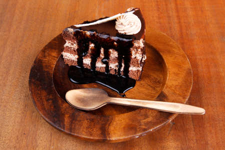 sweet brownie chocolate cream cake topped with white chocolate and cream with chocolate with...