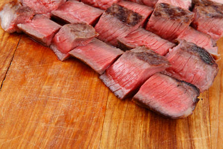 meat food : roast beef steak on wood plate isolate on white backgroundの写真素材