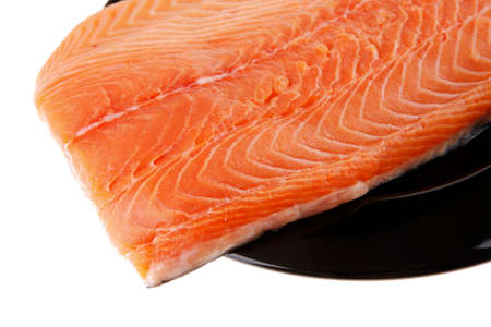 fresh uncooked red fish fillet on black over whiteの写真素材