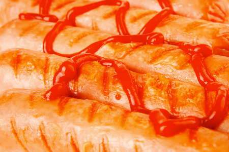 served beef red sausages with ketchup over white の写真素材