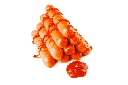 pyramide of sausages with ketchup over white backgroundの写真素材