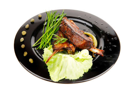 served savory plate: meat ribs with chives and red hot peppersの写真素材