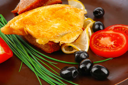 grilled fish fillet served with tomatoes,olives and bread