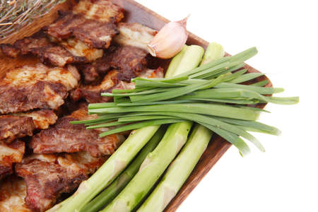 fresh grilled meat beef ribs with asparagus thyme and tomatoes on wooden plate isolated over white backgroundの写真素材