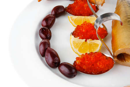 diet food - red caviar and smoked mackerel fish with lemon tomatoes and bread on white china plate isolated over white backgroundの写真素材