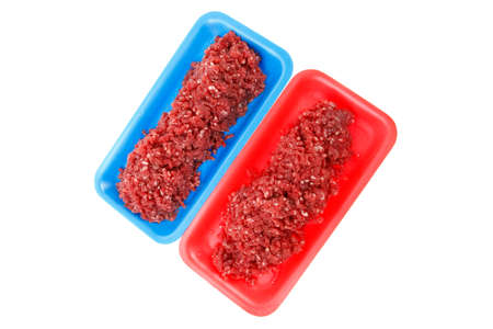 fresh raw mince beef meat on red and blue tray's isolated over white backgroundの写真素材