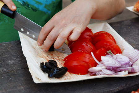 prepare hand made pizza with olives and tomatoes on wooden table on picnic with different kind of...