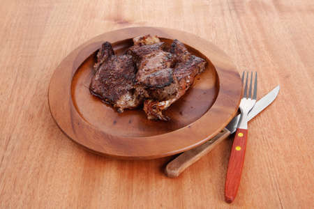 fresh roast beef barbecue on wood with cutlery over table bbqの写真素材