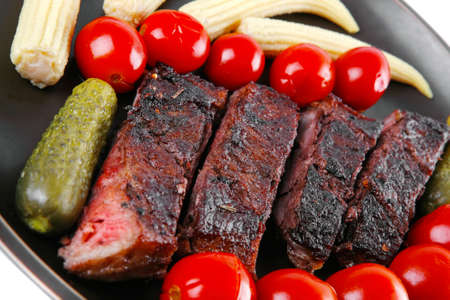grilled beef with baby corns and tomatoesの写真素材